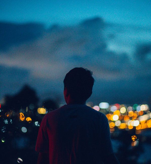 Silhouette of a person meditating against a vibrant background.